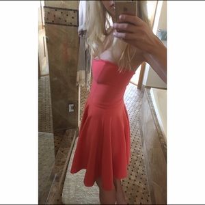 Coral pink strapless dress.